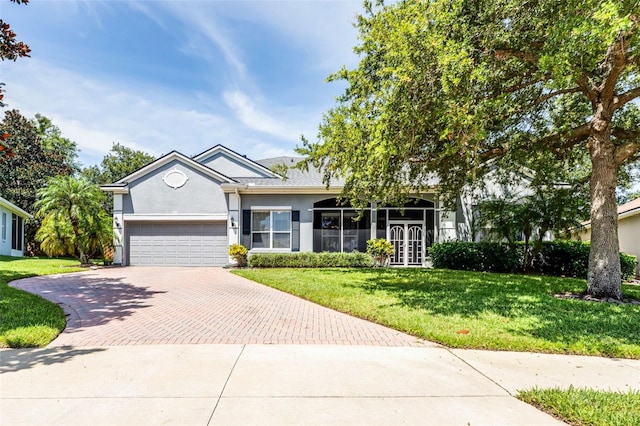2495 Squaw Crk, Clermont, FL 34711 - ranch-style house featuring decorative driveway, stucco siding, an attached garage, and a front yard
