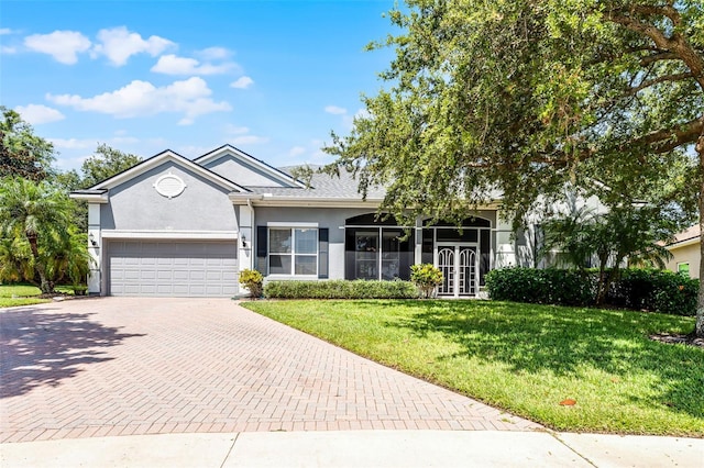 2495 Squaw Crk, Clermont, FL 34711 - ranch-style house with decorative driveway, stucco siding, a garage, and a front lawn