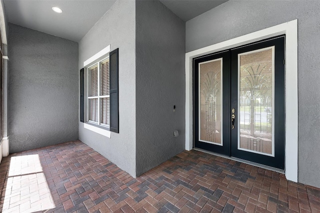 2495 Squaw Crk, Clermont, FL 34711 - view of exterior entry featuring french doors and stucco siding