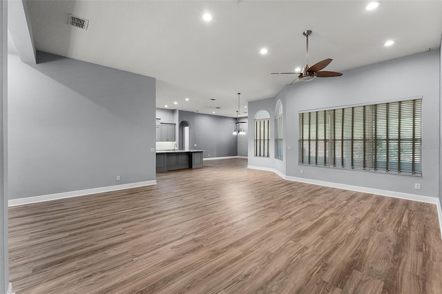 2495 Squaw Crk, Clermont, FL 34711 - unfurnished living room with ceiling fan, arched walkways, wood finished floors, and recessed lighting