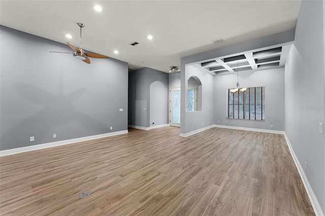 2495 Squaw Crk, Clermont, FL 34711 - spare room featuring arched walkways, a chandelier, coffered ceiling, recessed lighting, and light wood finished floors