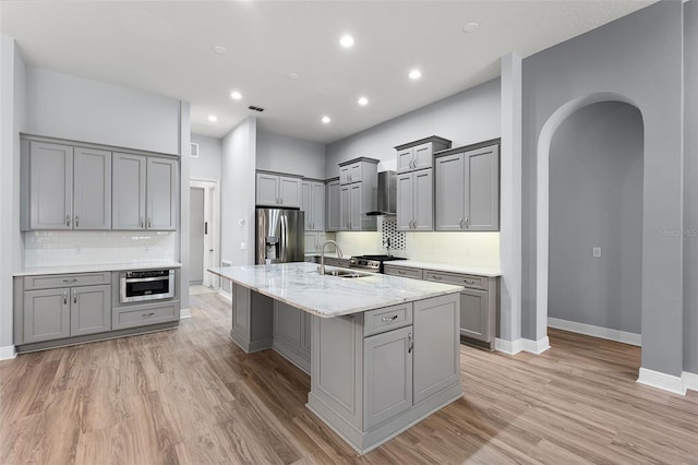 2495 Squaw Crk, Clermont, FL 34711 - kitchen with gray cabinetry, backsplash, arched walkways, and recessed lighting