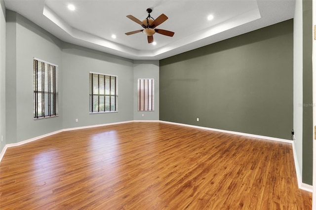 2495 Squaw Crk, Clermont, FL 34711 - unfurnished room with a tray ceiling, wood finished floors, recessed lighting, and a ceiling fan