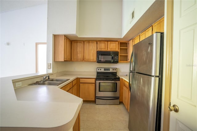 13037 Mulberry Park Dr Unit 5211, Orlando, FL 32821 - kitchen with stainless steel appliances, a peninsula, light countertops, a towering ceiling, and open shelves
