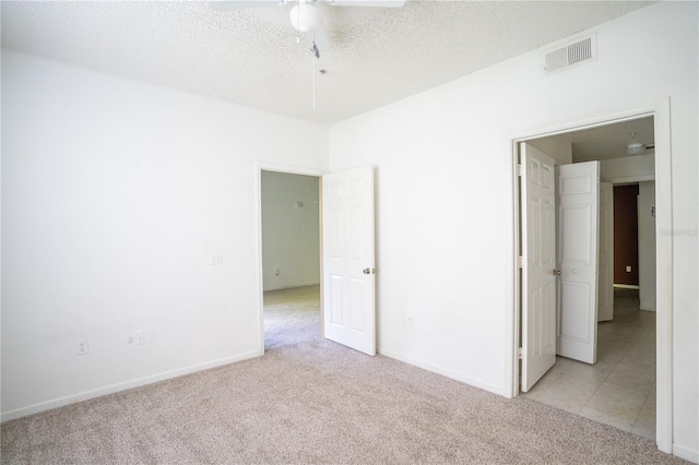 13037 Mulberry Park Dr Unit 5211, Orlando, FL 32821 - unfurnished bedroom featuring light carpet, a textured ceiling, and ceiling fan