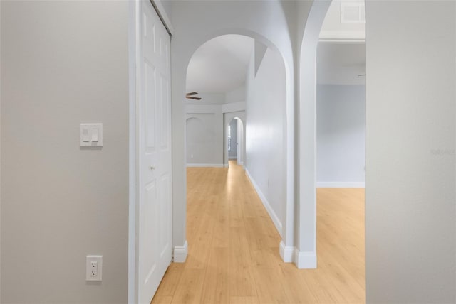 988 Vanderbilt Dr, Eustis, FL 32726 - hallway featuring light wood-style floors and arched walkways