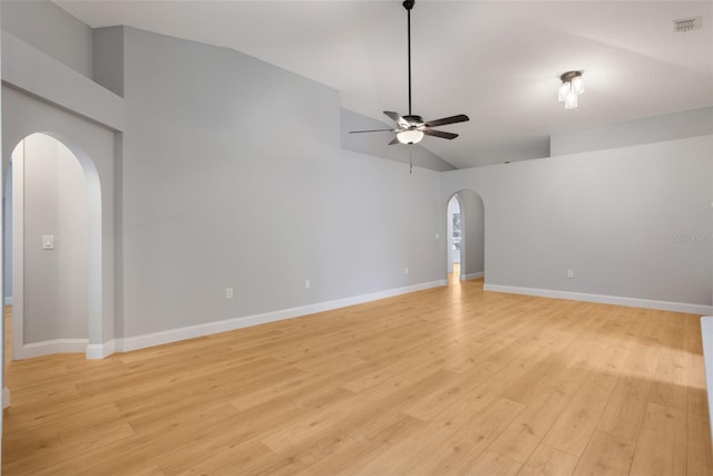 988 Vanderbilt Dr, Eustis, FL 32726 - empty room with arched walkways, ceiling fan, light wood finished floors, and high vaulted ceiling