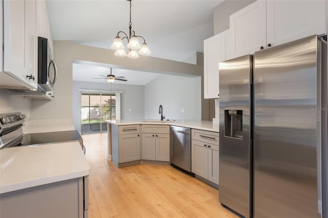 988 Vanderbilt Dr, Eustis, FL 32726 - kitchen featuring appliances with stainless steel finishes, a peninsula, ceiling fan, a chandelier, and light countertops