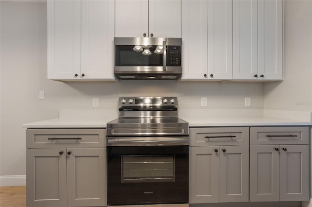988 Vanderbilt Dr, Eustis, FL 32726 - kitchen featuring stainless steel appliances, light countertops, and gray cabinets