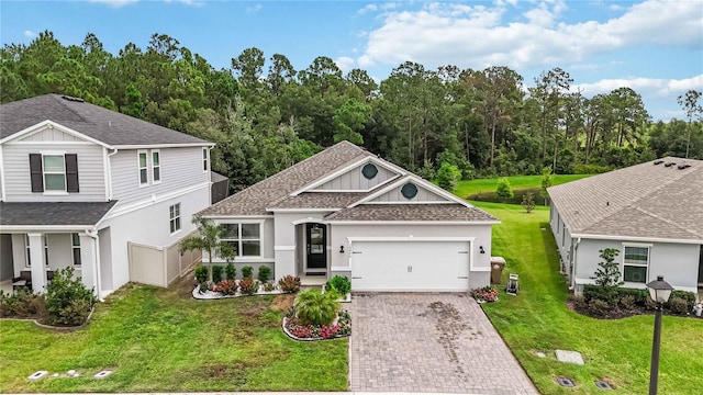 16400 Winding Preserve Cir, Clermont, FL 34714 - view of front of house with driveway, an attached garage, a shingled roof, and stucco siding