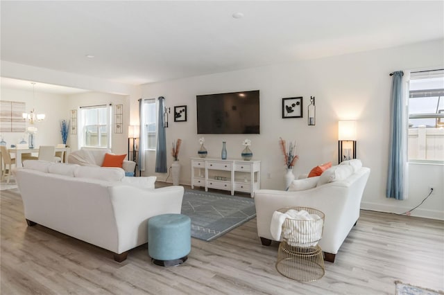 16400 Winding Preserve Cir, Clermont, FL 34714 - living room with a chandelier, wood finished floors, and healthy amount of natural light