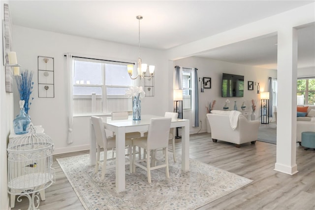 16400 Winding Preserve Cir, Clermont, FL 34714 - dining room with a chandelier and light wood-type flooring