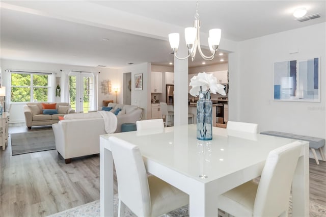 16400 Winding Preserve Cir, Clermont, FL 34714 - dining area with light wood-style flooring, a chandelier, and recessed lighting