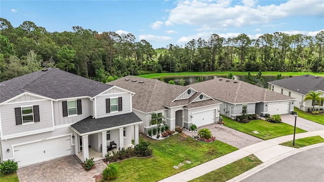16400 Winding Preserve Cir, Clermont, FL 34714 - view of front facade featuring decorative driveway, board and batten siding, roof with shingles, and a front lawn