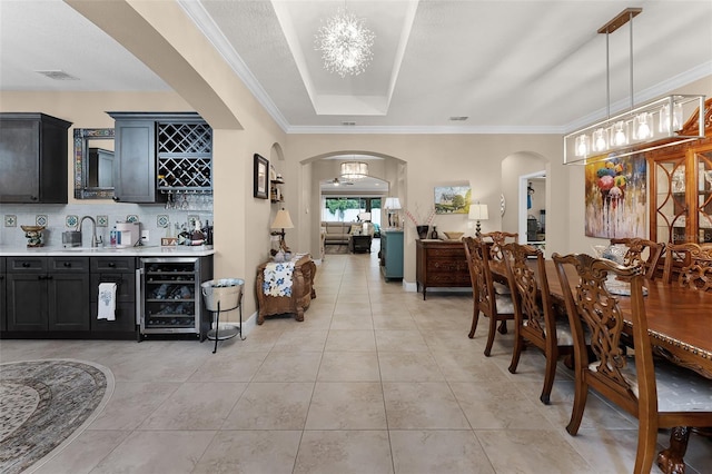 1208 Fieldstone Cir, Oviedo, FL 32765 - indoor dry bar featuring wine cooler, arched walkways, light tile patterned floors, decorative backsplash, and ornamental molding