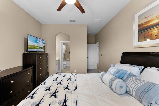 1208 Fieldstone Cir, Oviedo, FL 32765 - bedroom featuring arched walkways, ceiling fan, and connected bathroom