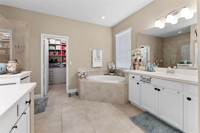 1208 Fieldstone Cir, Oviedo, FL 32765 - full bath featuring vanity, tile patterned floors, walk in shower, a garden tub, and a spacious closet