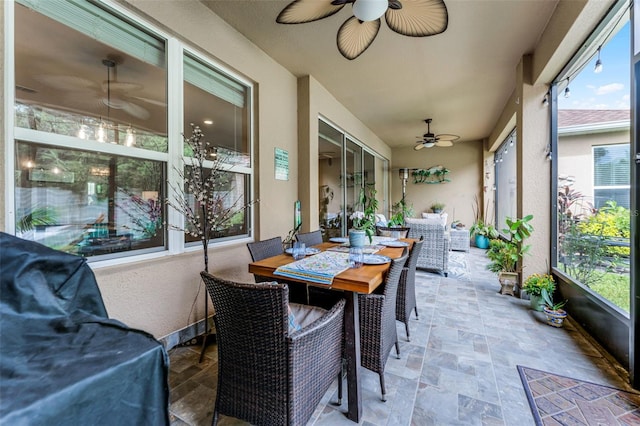 1208 Fieldstone Cir, Oviedo, FL 32765 - sunroom / solarium featuring a ceiling fan, stone finish floors, and outdoor dining area