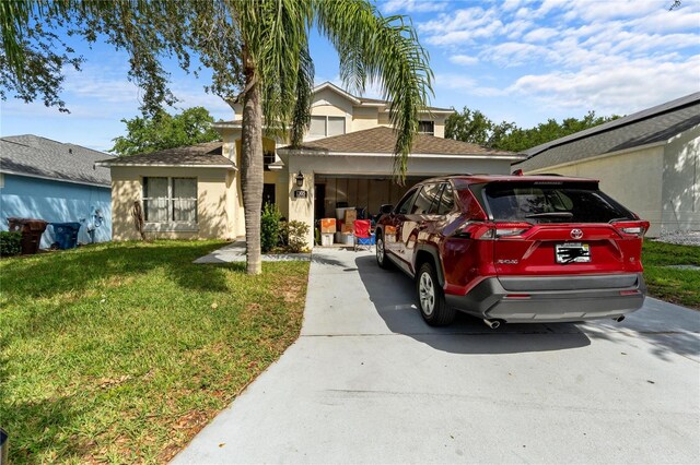1305 Rebecca Dr, Haines City, FL 33844 - view of front of home with driveway, a front lawn, an attached garage, and a shingled roof