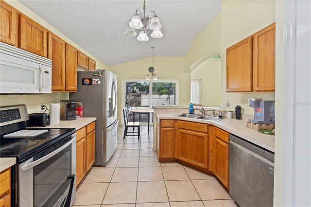 1305 Rebecca Dr, Haines City, FL 33844 - kitchen with stainless steel appliances, a chandelier, vaulted ceiling, light countertops, and light tile patterned flooring