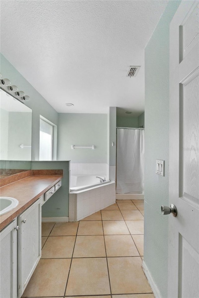 1305 Rebecca Dr, Haines City, FL 33844 - bathroom with vanity, a garden tub, tile patterned flooring, and a textured ceiling