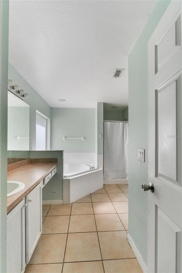 1305 Rebecca Dr, Haines City, FL 33844 - full bath with vanity, a bath, tile patterned flooring, and a textured ceiling