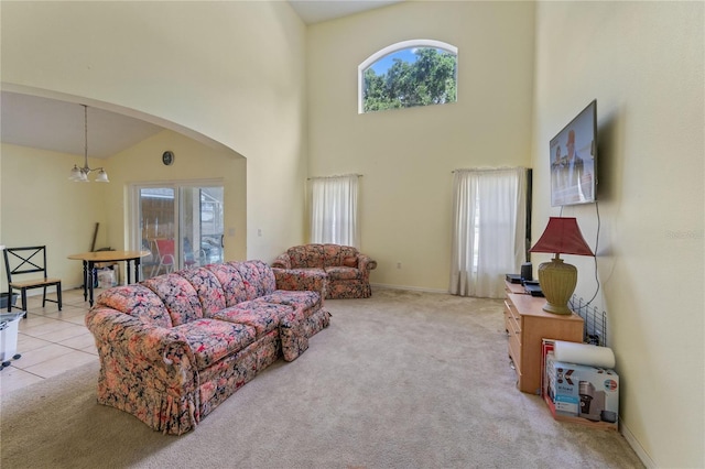 1305 Rebecca Dr, Haines City, FL 33844 - living area with plenty of natural light, a high ceiling, light carpet, arched walkways, and a chandelier