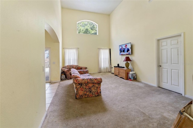 1305 Rebecca Dr, Haines City, FL 33844 - carpeted living room with arched walkways and a towering ceiling
