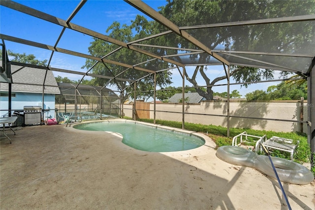 1305 Rebecca Dr, Haines City, FL 33844 - view of swimming pool featuring a patio area, a fenced backyard, glass enclosure, and area for grilling