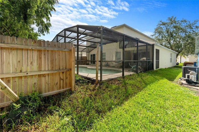 1305 Rebecca Dr, Haines City, FL 33844 - rear view of house with an outdoor pool and a lanai