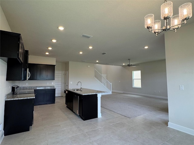 4101 Sagefield Dr, Harmony, FL 34773 - kitchen featuring light carpet, recessed lighting, dark cabinetry, light tile patterned floors, and range