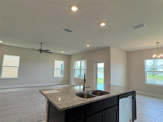 4101 Sagefield Dr, Harmony, FL 34773 - kitchen with dishwasher, open floor plan, light stone countertops, a center island with sink, and recessed lighting