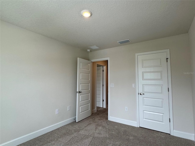 4101 Sagefield Dr, Harmony, FL 34773 - unfurnished bedroom featuring a textured ceiling and carpet floors