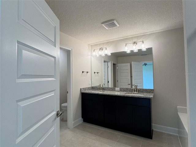 4101 Sagefield Dr, Harmony, FL 34773 - full bathroom with double vanity, tile patterned flooring, and a textured ceiling