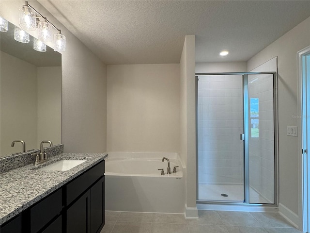 4101 Sagefield Dr, Harmony, FL 34773 - bathroom featuring vanity, a stall shower, a garden tub, tile patterned flooring, and a textured ceiling