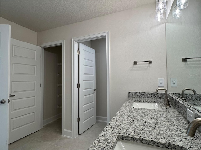 4101 Sagefield Dr, Harmony, FL 34773 - bathroom with tile patterned flooring, double vanity, and a textured ceiling