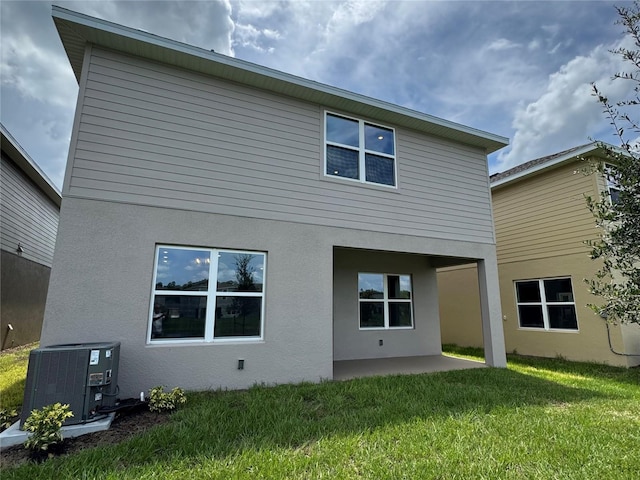 4101 Sagefield Dr, Harmony, FL 34773 - back of property with stucco siding, a patio area, and a yard