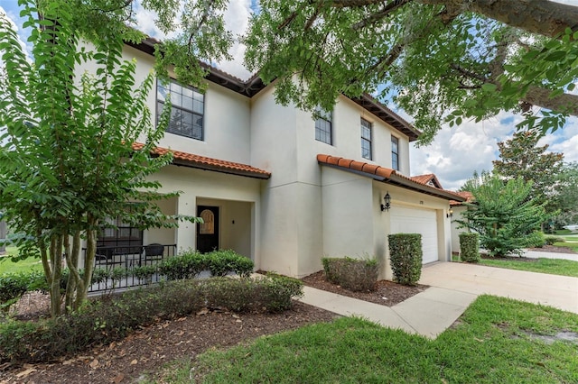 2792 Roccella Ct, Kissimmee, FL 34747 - mediterranean / spanish home featuring a tiled roof, concrete driveway, stucco siding, and an attached garage