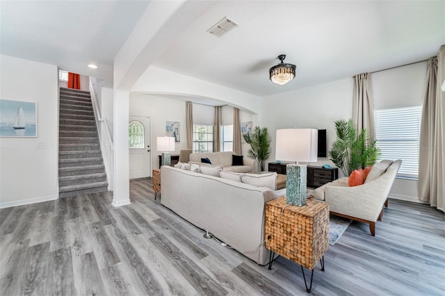 2792 Roccella Ct, Kissimmee, FL 34747 - living area featuring wood finished floors, stairs, arched walkways, and recessed lighting