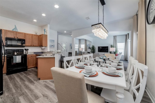 2792 Roccella Ct, Kissimmee, FL 34747 - dining space featuring recessed lighting, wood finished floors, and a chandelier