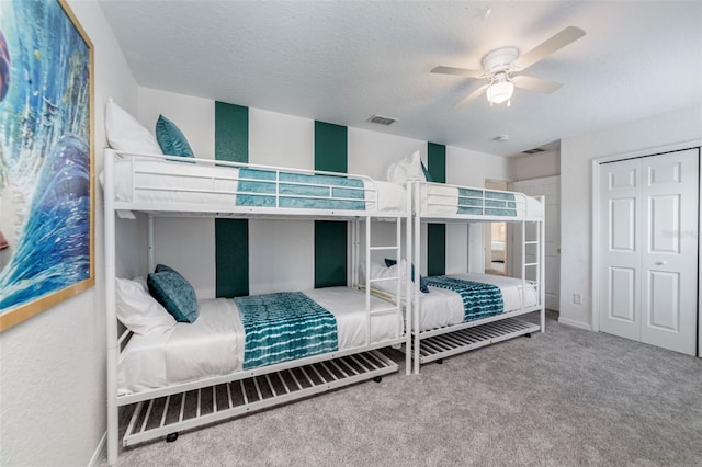 2792 Roccella Ct, Kissimmee, FL 34747 - bedroom featuring carpet floors, a ceiling fan, a closet, and a textured ceiling