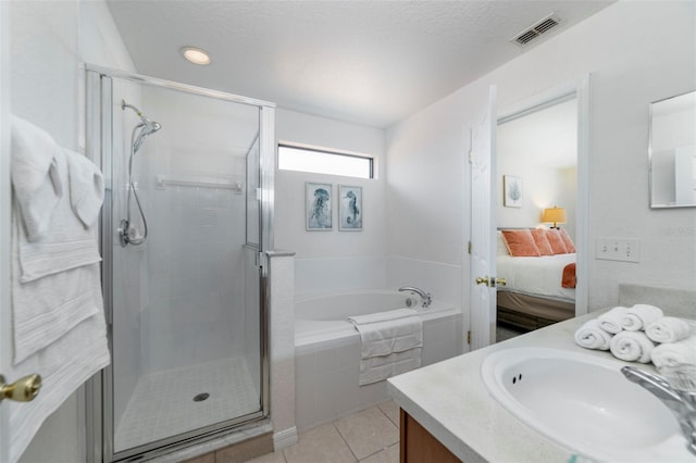 2792 Roccella Ct, Kissimmee, FL 34747 - full bathroom featuring vanity, a bath, ensuite bath, a stall shower, and tile patterned floors