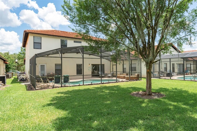 2792 Roccella Ct, Kissimmee, FL 34747 - rear view of house featuring stucco siding, a tile roof, an outdoor pool, and a lawn