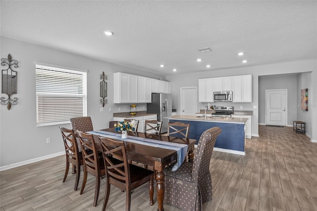 4491 Holstein St, Saint Cloud, FL 34772 - dining room with light wood-type flooring, recessed lighting, and a textured ceiling