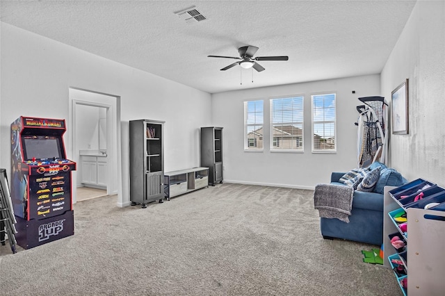 4491 Holstein St, Saint Cloud, FL 34772 - game room with carpet floors, a ceiling fan, and a textured ceiling