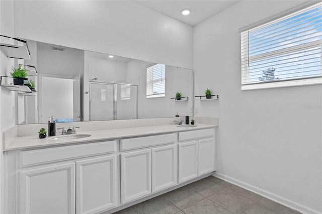 4491 Holstein St, Saint Cloud, FL 34772 - full bathroom featuring plenty of natural light, a shower stall, double vanity, and tile patterned flooring