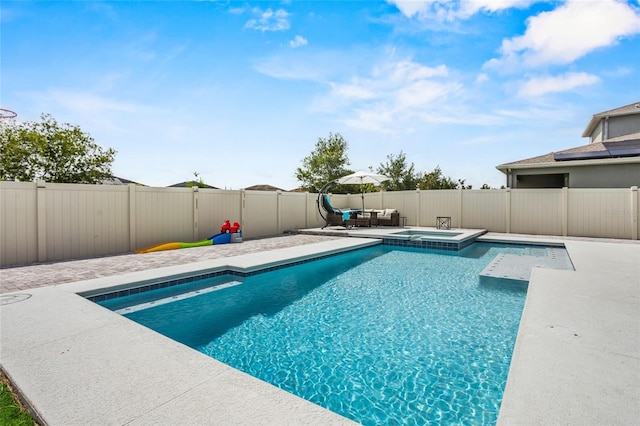 4491 Holstein St, Saint Cloud, FL 34772 - view of swimming pool featuring a fenced backyard, a pool with connected hot tub, a patio, and an outdoor living space