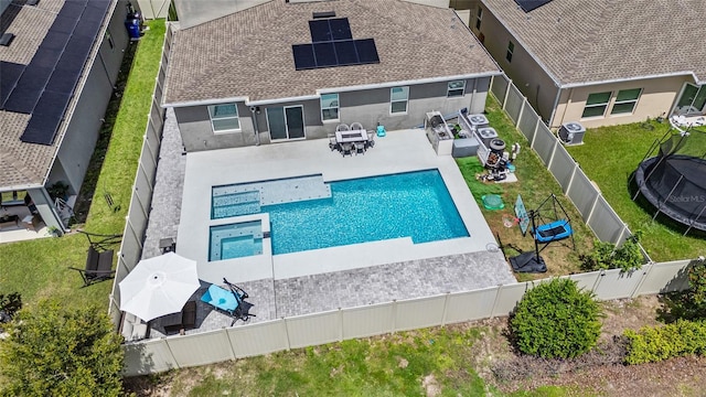 4491 Holstein St, Saint Cloud, FL 34772 - view of swimming pool featuring a fenced backyard, a patio area, a pool with connected hot tub, and outdoor dining area