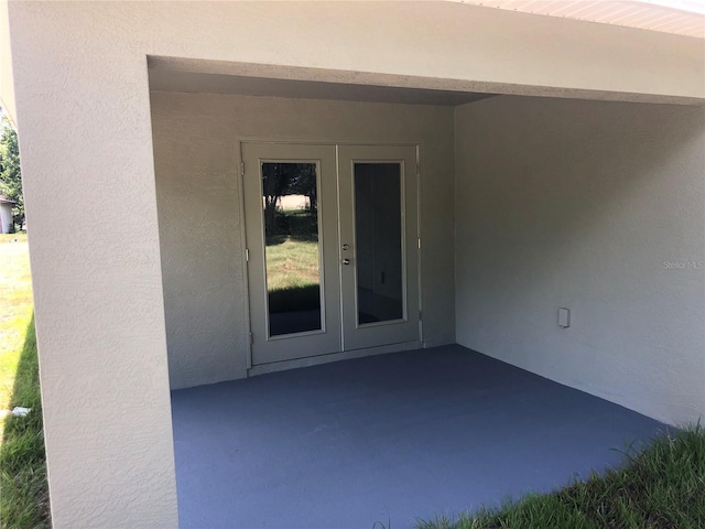 120 Highland Ave, Auburndale, FL 33823 - property entrance with stucco siding, french doors, and a patio