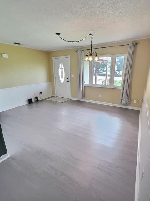 520 Jupiter Blvd NW, Palm Bay, FL 32907 - foyer entrance with plenty of natural light, wood finished floors, a textured ceiling, and a chandelier